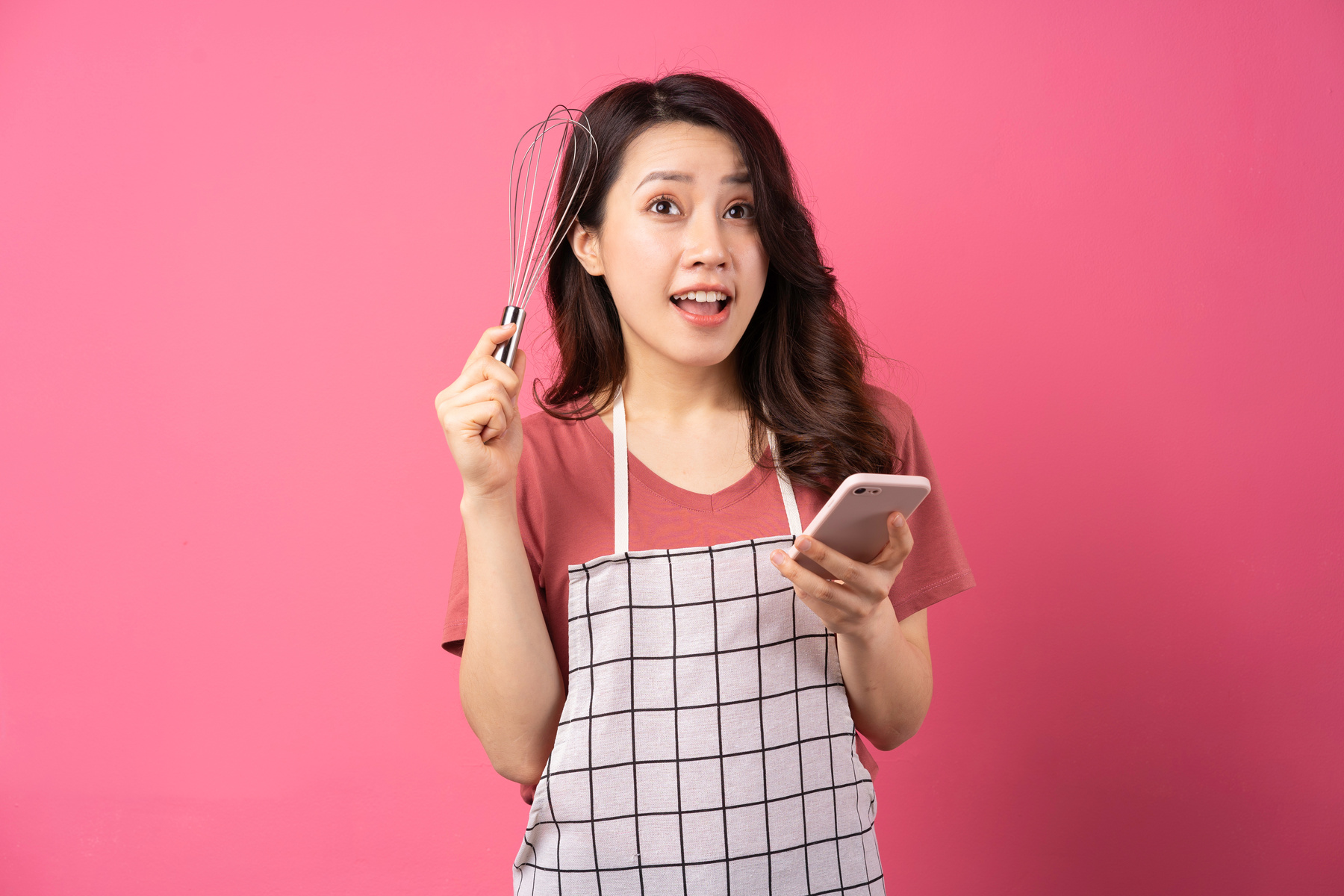 Housewife Holding Whisk Cheerful Expressive over Pink Background